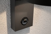 Black aluminium wall motion sensor mounted on textured grey wall for outdoor lighting and security