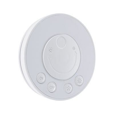 Round white plastic control panel with buttons for on, off, and light adjustment