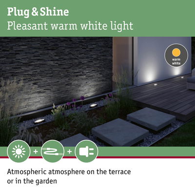 Outdoor warm white ground lights creating atmospheric terrace and garden illumination