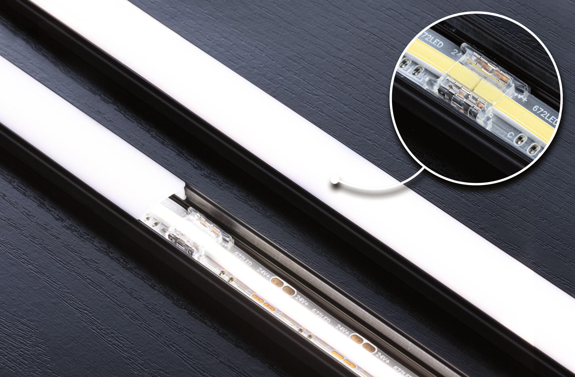 Black LED strip with white diffuser and close-up of LED connector for modern lighting solutions