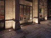 Warm white LED ground recessed light in stone wall for atmospheric outdoor facade lighting