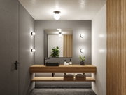 Modern bathroom with wooden vanity, black sink, and round wall lights in grey and wood design