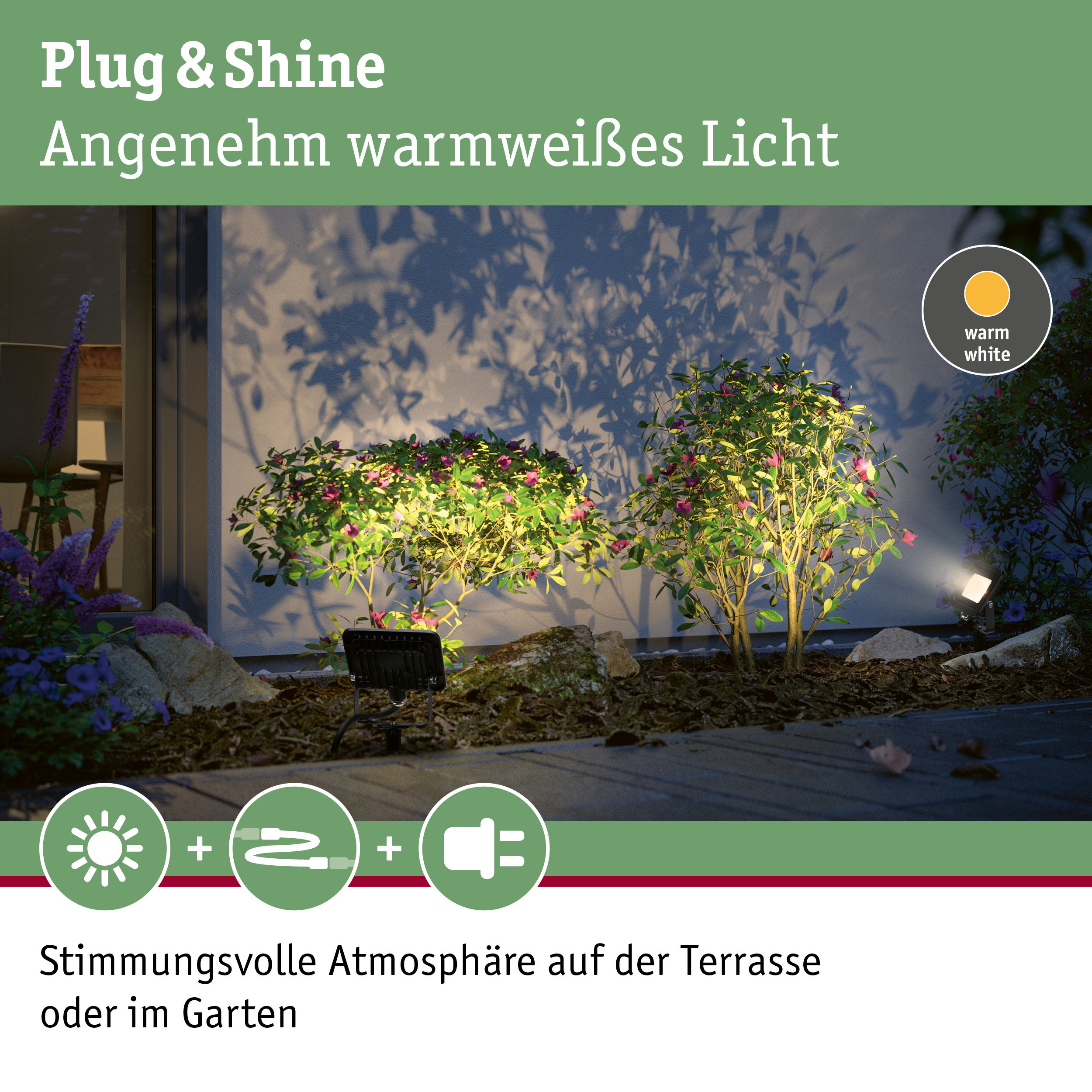 Außenstrahler mit warmweißem Licht beleuchtet grüne Pflanzen und schafft gemütliche Gartenatmosphäre